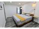 Bedroom with wood-look floors, platform bed, a closet, and modern pendant lighting at 249 E Minnesota St, Indianapolis, IN 46225