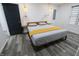 Bedroom with modern pendant lighting, a platform bed, and wood-look floors at 249 E Minnesota St, Indianapolis, IN 46225