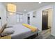 This bedroom features bright white walls, wood-look floors, a platform bed, and modern lighting at 249 E Minnesota St, Indianapolis, IN 46225
