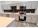Bright kitchen with stainless steel appliances, light grey cabinets, and black backsplash at 249 E Minnesota St, Indianapolis, IN 46225