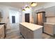 Bright kitchen boasts gray cabinets, stainless appliances, quartz countertops, and stylish pendant lighting at 249 E Minnesota St, Indianapolis, IN 46225