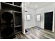 A well-lit laundry room featuring new stackable washer and dryer and convenient storage shelves at 249 E Minnesota St, Indianapolis, IN 46225
