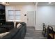 Bright living room features a dark couch, light grey flooring, and neutral walls at 249 E Minnesota St, Indianapolis, IN 46225