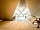 An attic space with grey carpets and multiple dormers at 26 N Holmes Ave, Indianapolis, IN 46222