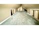 An attic space, with grey carpets and off-white trim at 26 N Holmes Ave, Indianapolis, IN 46222