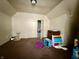 Bedroom with a window, brown carpet and off-white walls at 26 N Holmes Ave, Indianapolis, IN 46222