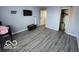Bright bedroom with wood-look floors, closet, and ample space at 2706 Country Estates Dr, Indianapolis, IN 46227