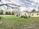 A well-maintained backyard with a lush lawn, landscaping, and a barbecue grill area at 2816 Canterbury Ln, Indianapolis, IN 46220