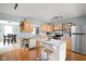 Bright kitchen featuring stainless steel appliances, wooden cabinets, marble countertops, and a central island at 2816 Canterbury Ln, Indianapolis, IN 46220