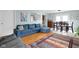 Cozy living room featuring a large sectional sofa, hardwood floors, and a vibrant area rug at 2816 Canterbury Ln, Indianapolis, IN 46220