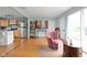 Open-concept living area with hardwood floors, a cozy chair, a bookshelf, and a doorway at 2816 Canterbury Ln, Indianapolis, IN 46220