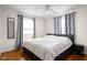 Comfortable bedroom with hardwood floors, a ceiling fan, and plenty of natural light from two windows at 2816 Canterbury Ln, Indianapolis, IN 46220