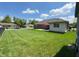 Expansive backyard with lush green grass, patio, mature trees, and neighboring homes create a serene environment at 300 Kathryn Ct, Clayton, IN 46118