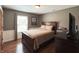Comfortable bedroom features hardwood floors, natural light, and calming neutral paint tones at 300 Kathryn Ct, Clayton, IN 46118