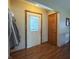 Inviting hallway with a white paneled front door, wood trim, and a neutral wall color at 300 Kathryn Ct, Clayton, IN 46118