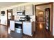 Well-equipped kitchen featuring stainless steel appliances, granite countertops, grey cabinets, and a seamless flow to other living areas at 300 Kathryn Ct, Clayton, IN 46118