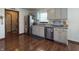 Efficient kitchen with stainless steel appliances, granite countertops, and ample grey cabinetry for storage and convenience at 300 Kathryn Ct, Clayton, IN 46118