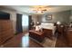Stylish main bedroom has a king bed, ceiling fan, and wooden furnishings, creating a comfortable and inviting retreat at 300 Kathryn Ct, Clayton, IN 46118