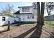 Quaint two-story home featuring a spacious yard with mature trees and a detached garage at 3438 Olive St, Indianapolis, IN 46227