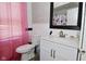 Bathroom features wood-look accent wall, updated fixtures, and a toilet at 3438 Olive St, Indianapolis, IN 46227