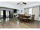 Open-concept dining area boasts lots of natural light, modern fan and wood burning fireplace at 3438 Olive St, Indianapolis, IN 46227