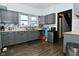 Well-lit kitchen with gray cabinets, stainless steel appliances, and modern backsplash at 3438 Olive St, Indianapolis, IN 46227