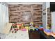 playroom features hardwood floors, wood paneled accent wall, play area, and lots of toys at 3438 Olive St, Indianapolis, IN 46227