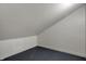 The attic boasts sloped ceilings, neutral walls, and a gray floor, creating a versatile storage space at 3484 Birchwood Ave, Indianapolis, IN 46205