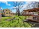 Expansive backyard featuring a gazebo, lush green lawn, and meticulously maintained landscaping at 3484 Birchwood Ave, Indianapolis, IN 46205
