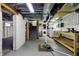 Spacious unfinished basement features painted walls, utilities, and stairs for potential renovation at 3484 Birchwood Ave, Indianapolis, IN 46205
