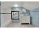 A full bathroom with modern vanity, subway tile shower and coordinating blue walls at 3484 Birchwood Ave, Indianapolis, IN 46205