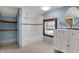 Stylishly renovated bathroom with a shower-tub, modern vanity, and blue wall accents at 3484 Birchwood Ave, Indianapolis, IN 46205