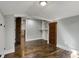 A sunlit attic bedroom with hardwood floors features a built-in closet and neutral paint at 3484 Birchwood Ave, Indianapolis, IN 46205