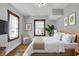 Bright bedroom with hardwood floors, large windows, and modern decor at 3484 Birchwood Ave, Indianapolis, IN 46205