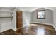 A sunlit attic bedroom features hardwood floors, built-in dresser, and neutral paint at 3484 Birchwood Ave, Indianapolis, IN 46205