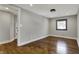 Well-lit bedroom with hardwood floors, neutral walls, and a window offering natural light at 3484 Birchwood Ave, Indianapolis, IN 46205
