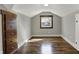 A sunlit attic bedroom features hardwood floors, built-in dresser, and neutral paint at 3484 Birchwood Ave, Indianapolis, IN 46205