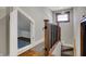 Hallway featuring bonus room, wood and metal railing and carpeted stairs at 3484 Birchwood Ave, Indianapolis, IN 46205