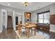 Dining room with hardwood floors, staircase and an open view to the kitchen at 3484 Birchwood Ave, Indianapolis, IN 46205