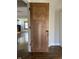 A newly stained interior door with black hardware opens to reveal hardwood flooring and natural light at 3484 Birchwood Ave, Indianapolis, IN 46205