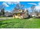 Beautifully landscaped lawn and exterior home view featuring a classic-style front porch at 3484 Birchwood Ave, Indianapolis, IN 46205