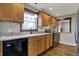 Updated kitchen with wooden cabinets, stainless steel appliances, and granite countertops at 3484 Birchwood Ave, Indianapolis, IN 46205
