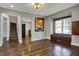 Bright living area featuring hardwood floors and open access to a kitchen with a breakfast bar at 3484 Birchwood Ave, Indianapolis, IN 46205