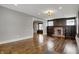 A spacious living room with hardwood floors, a brick fireplace, and large windows at 3484 Birchwood Ave, Indianapolis, IN 46205