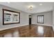 Bright living room with hardwood floors, many windows and neutral colored walls at 3484 Birchwood Ave, Indianapolis, IN 46205
