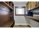 A mud room featuring custom wood cabinets and hooks for coats and bags at 3484 Birchwood Ave, Indianapolis, IN 46205