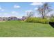 Picturesque backyard with lush green grass, beautiful trees, and neighborhood homes in background at 3799 Hoosier Down Dr, Bargersville, IN 46106