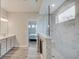 Modern bathroom features marble-tiled shower, dual vanity, and seamless glass door to the shower at 3799 Hoosier Down Dr, Bargersville, IN 46106