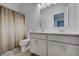 Bright bathroom features a double sink vanity, toilet, and shower with a curtain at 3799 Hoosier Down Dr, Bargersville, IN 46106