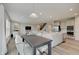 Open floor plan showcasing a dining table, kitchen island, and a cozy living room at 3799 Hoosier Down Dr, Bargersville, IN 46106
